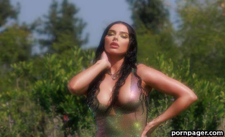 The Ultimate Guide to Building a Website for Adult Bars near me in Breda Outdoor portrait of a woman with long dark hair wearing a sheer mesh top, posing with one hand on her neck; gold makeup and a confident expression.